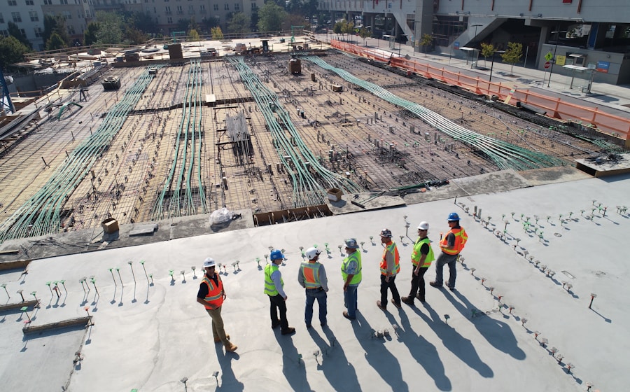 Construction team reviewing plans on site for coordinated scheduling